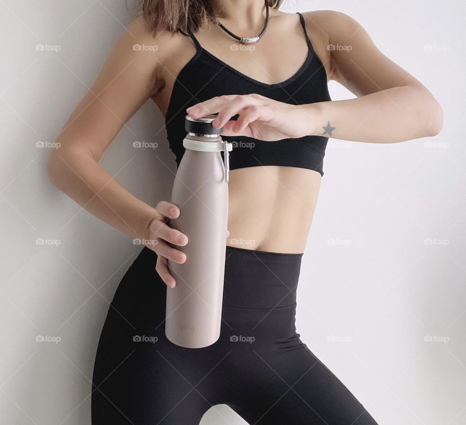 Sporty fitness asian woman with water bottle 