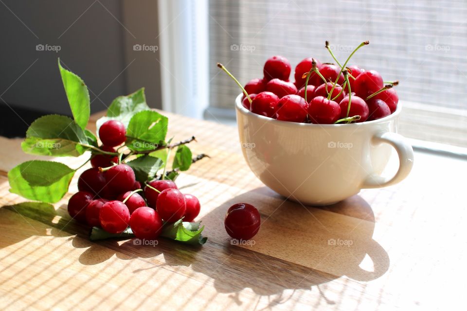 Fresh juicy cherries in plate