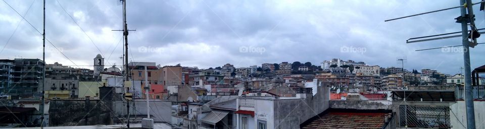Cloudy sky on town roofs