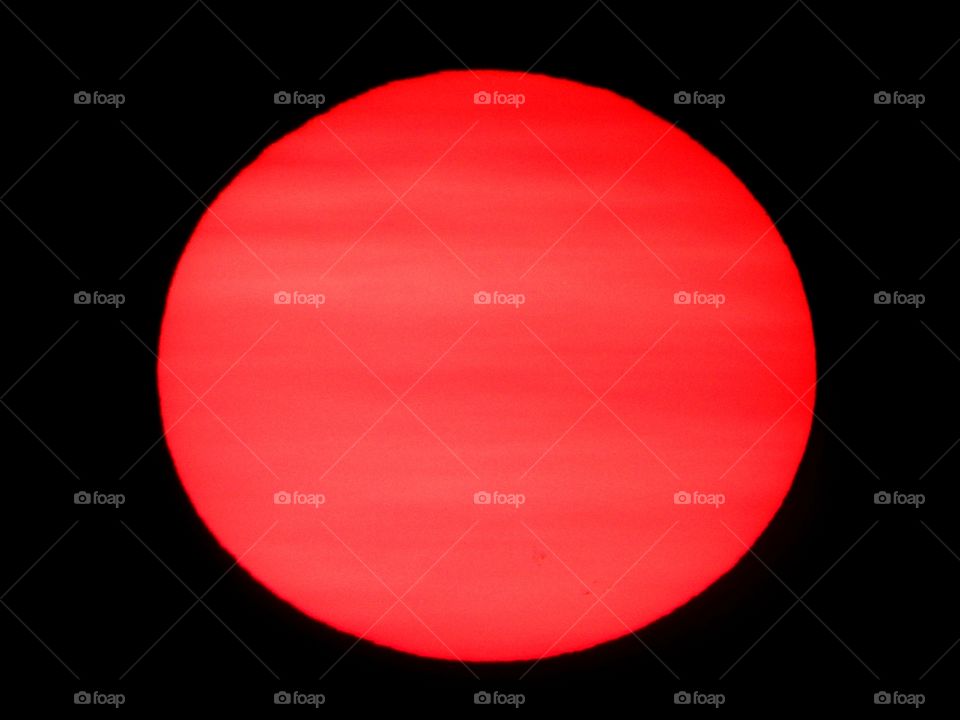 Color Red - The sun was a glowing red orb in the sky. A red sun over the bay in the late evening is a sight to behold. 