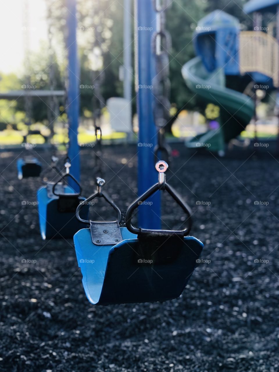 The lonely blue swing in the empty park