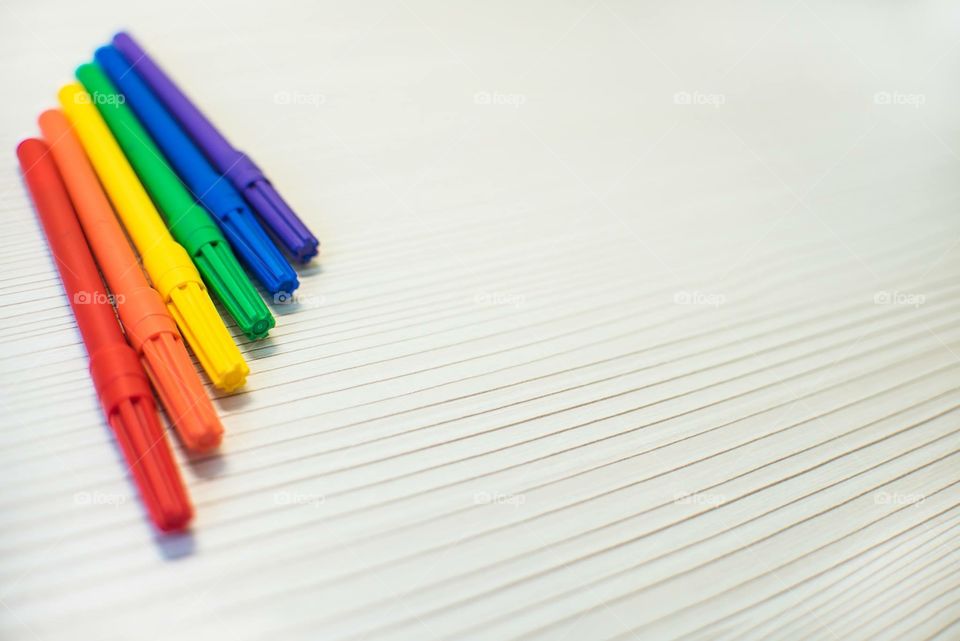 Multicolored Markers On A Wooden Background