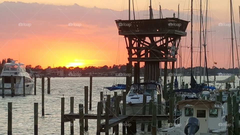 Bright orange sunset from pier in Stuart Florida