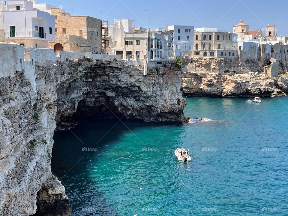 Urban nature - Water: old Mediterranean city on the high stone cliff shore with the big cave under 