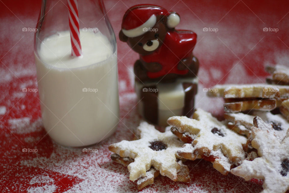 Sweet cookies with powdered sugar, milk and chocolate bear