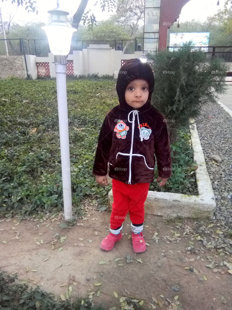 a cute little boy in a park.