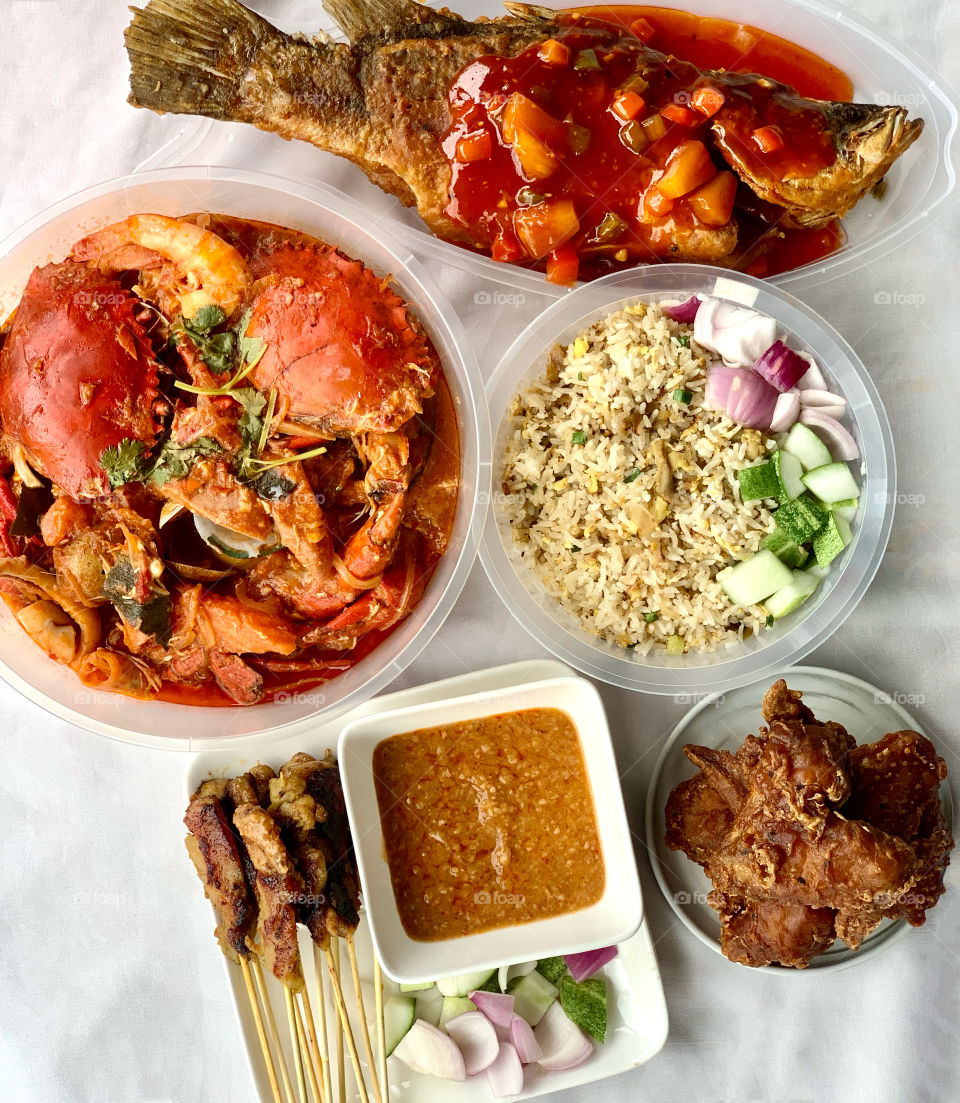 Halal feast consisting of chilli crab shellout, chicken satay fried rice, chicken satay sticks, sweet sour seabass and chicken wings 