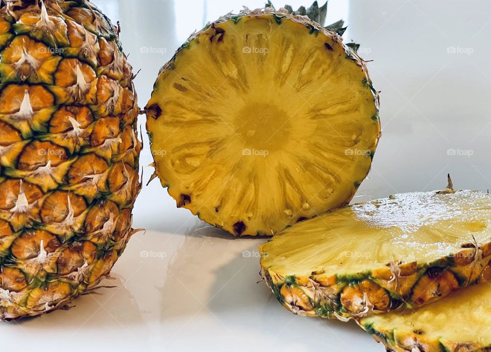 Juicy yellow pineapple slices from above, tropical fruit, Latin American fruit, edible bromeliad 