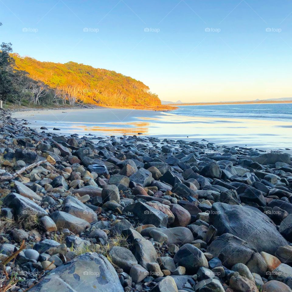 Rocky beach in the early morning light blues