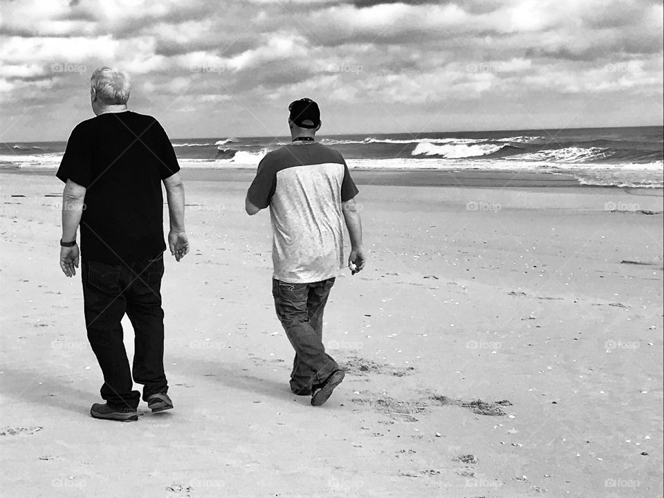 Father and Son walking at Hammock Dunes Beach in Florida 