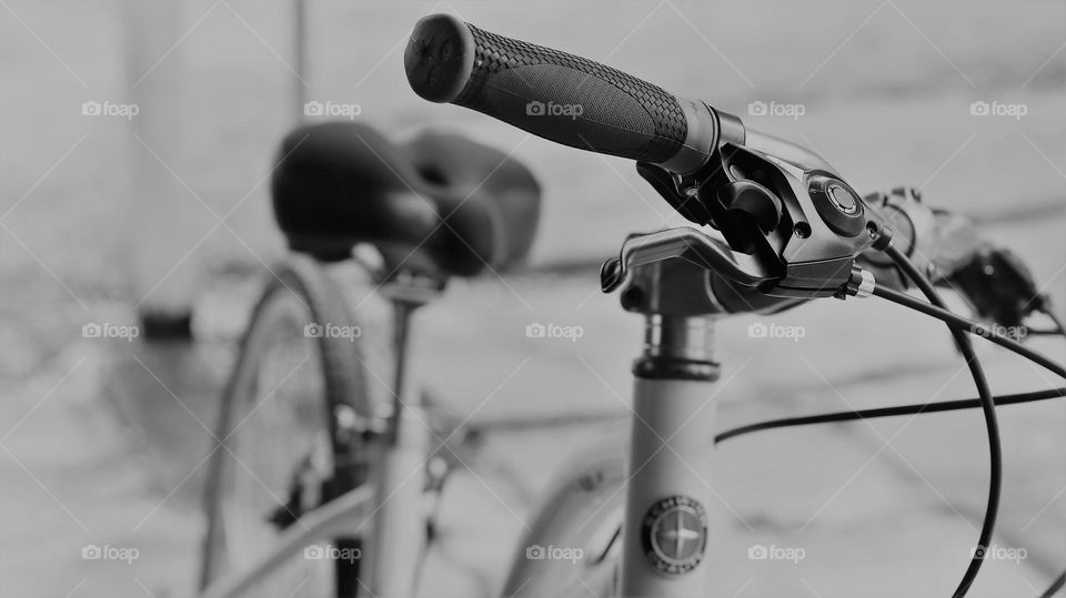 Black and white of one lonely bicycle closeup on handlebars 