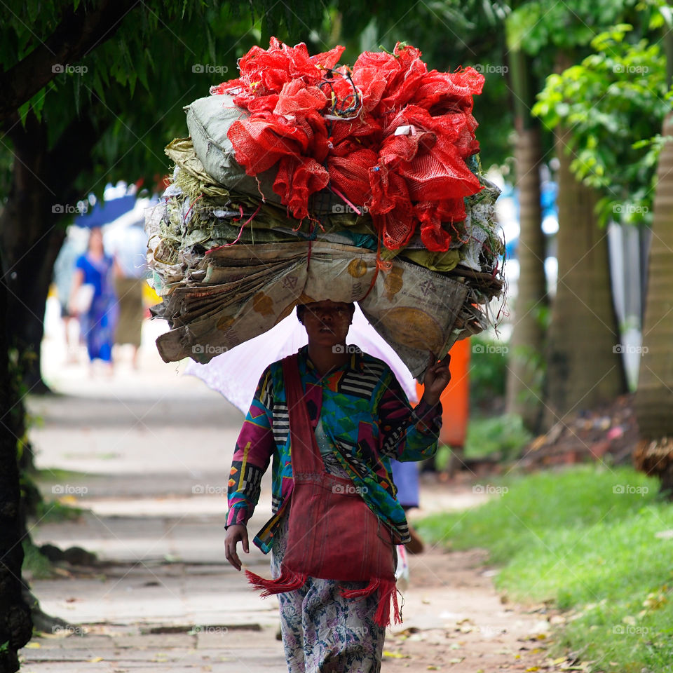 The Burmese woman carrying stuff on her head