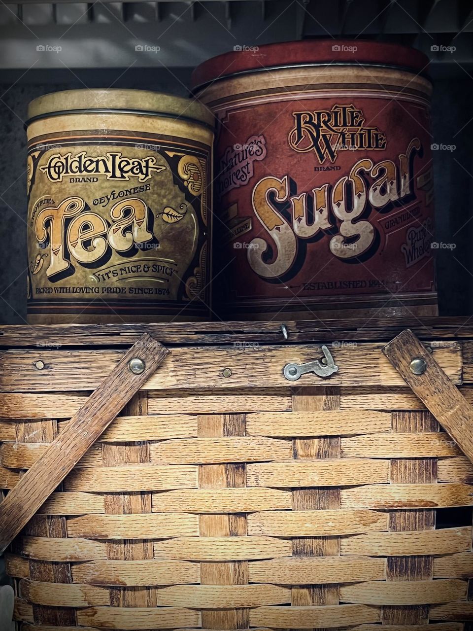 Antique tea and sugar containers on a picnic basket 🧺