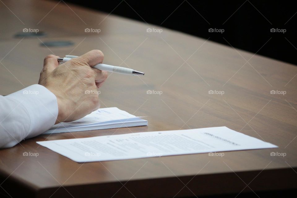 Hand and pen with list of necessities