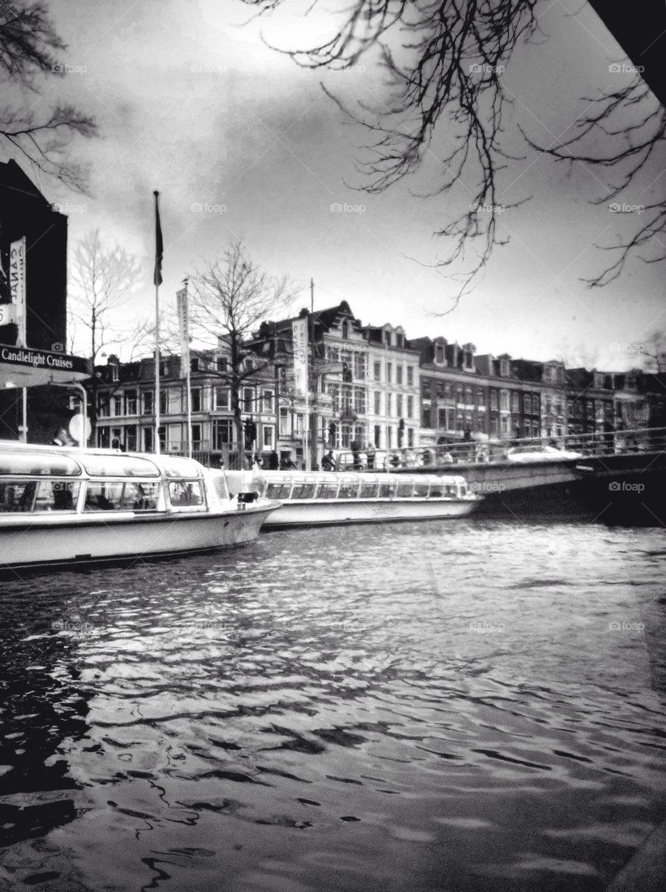 Tourist take a boat trip along the river in Amsterdam.