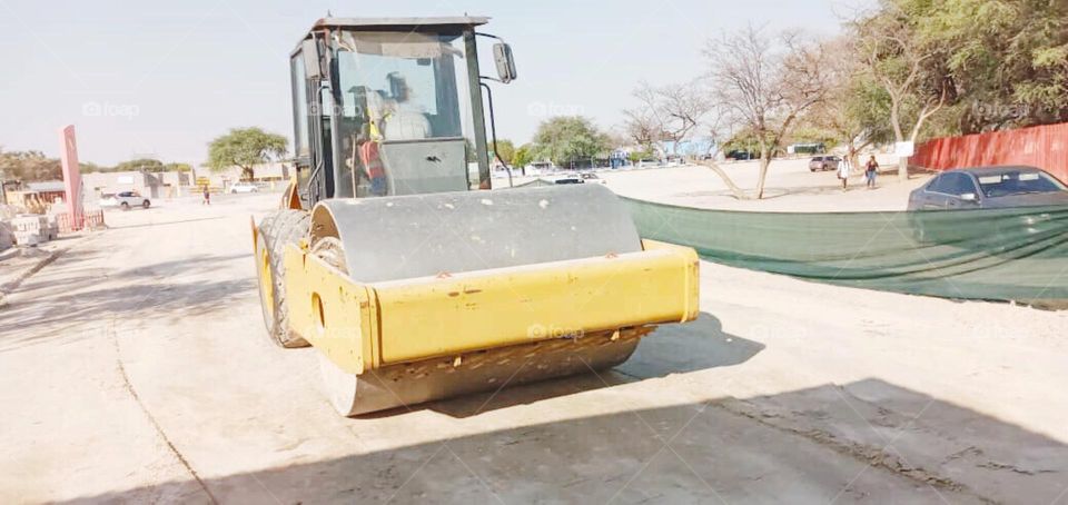 Road Roller machine at the site, it level up the sand until it become smooth as in the picture, this was at the construction site before  installing interlock .