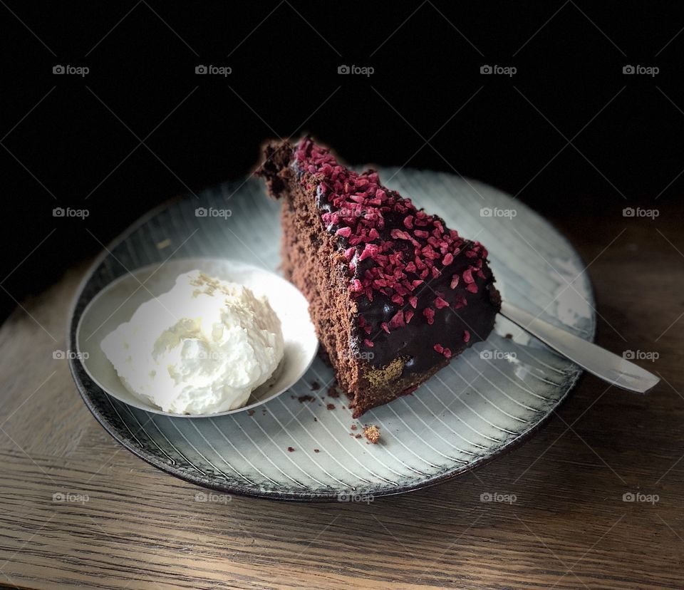 Chocolate and raspberry cake with wiped cream 