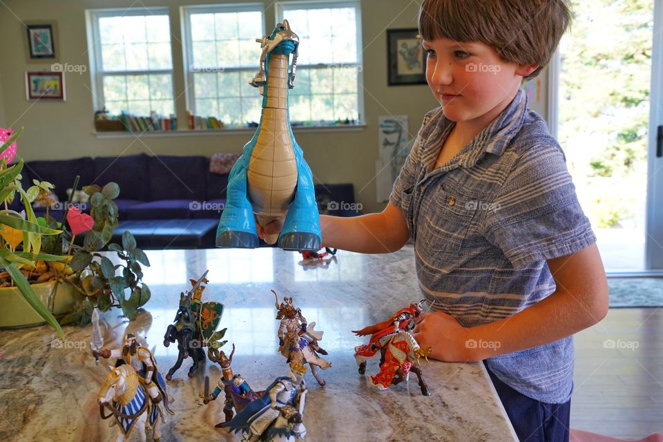 Boy Playing With Toy Collection