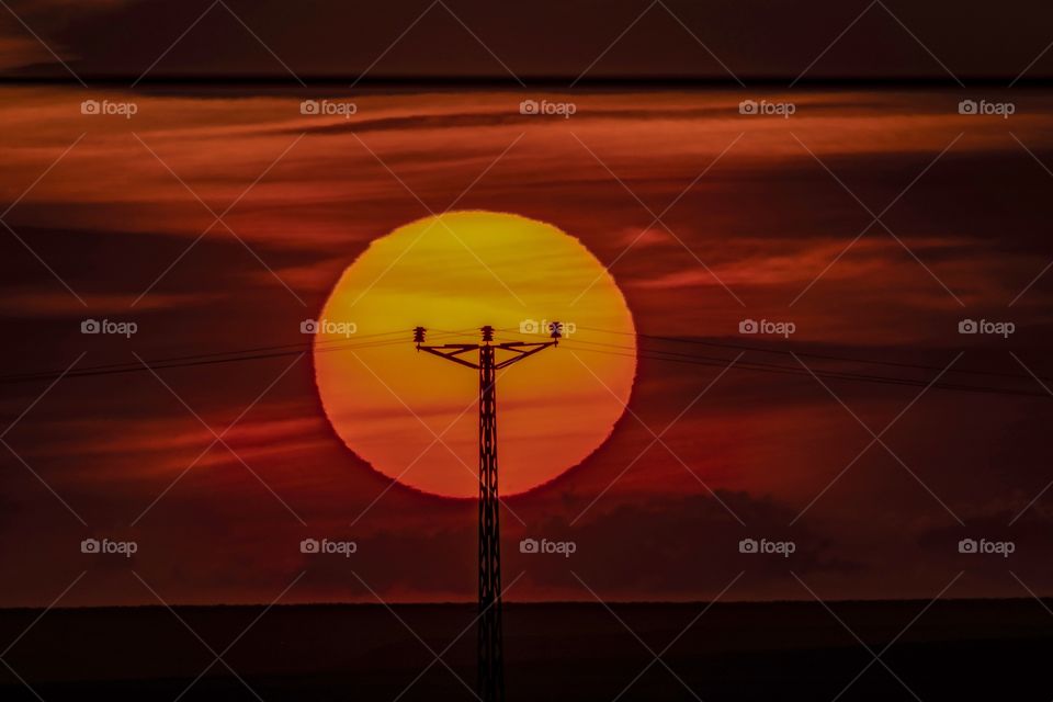 electricity pylon at sunset