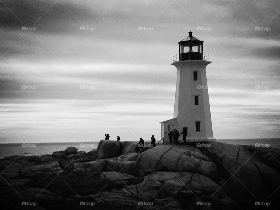 Beacon. Famous lighthouse at Peggy's Cove, Nova Scotia - black and white architecture mission 
