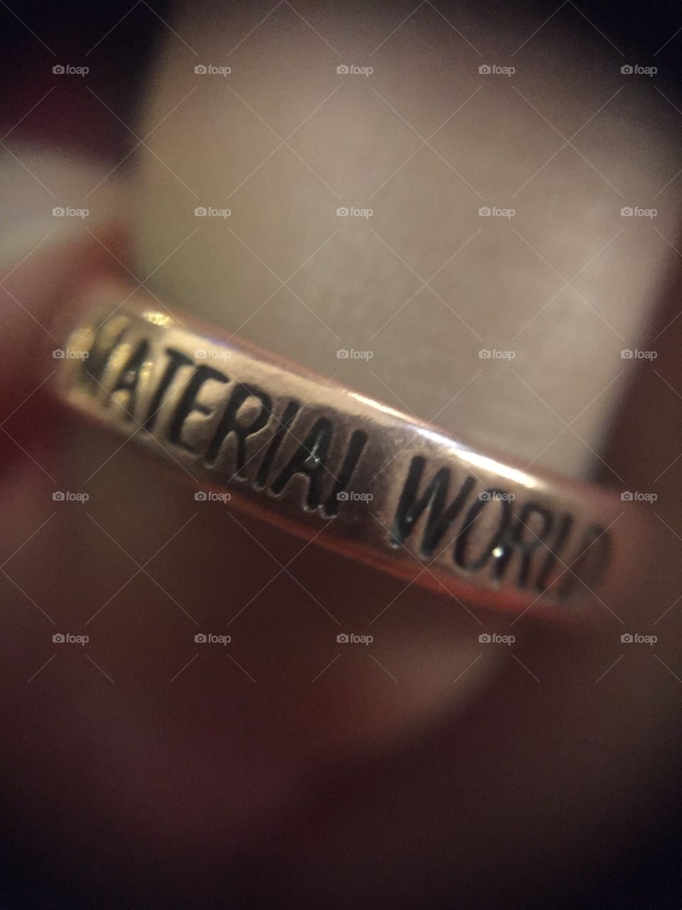 This is a macro shot of one of my favorite rings. It says "We Are Living A Material World," probably inspired by the popular Madonna song "Material Girl."