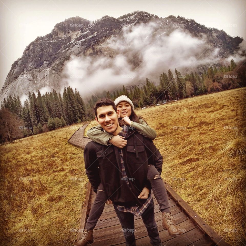 Happy young couple having fun together in front of mountain