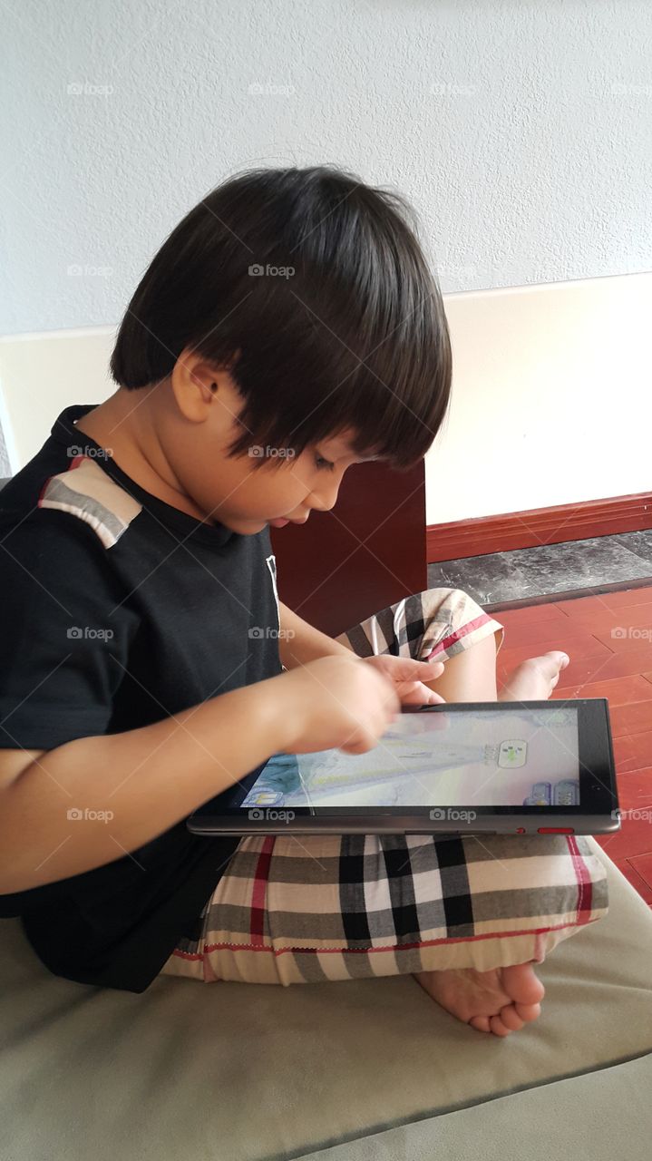 kid playing tablet ipad. learning playing with new technology