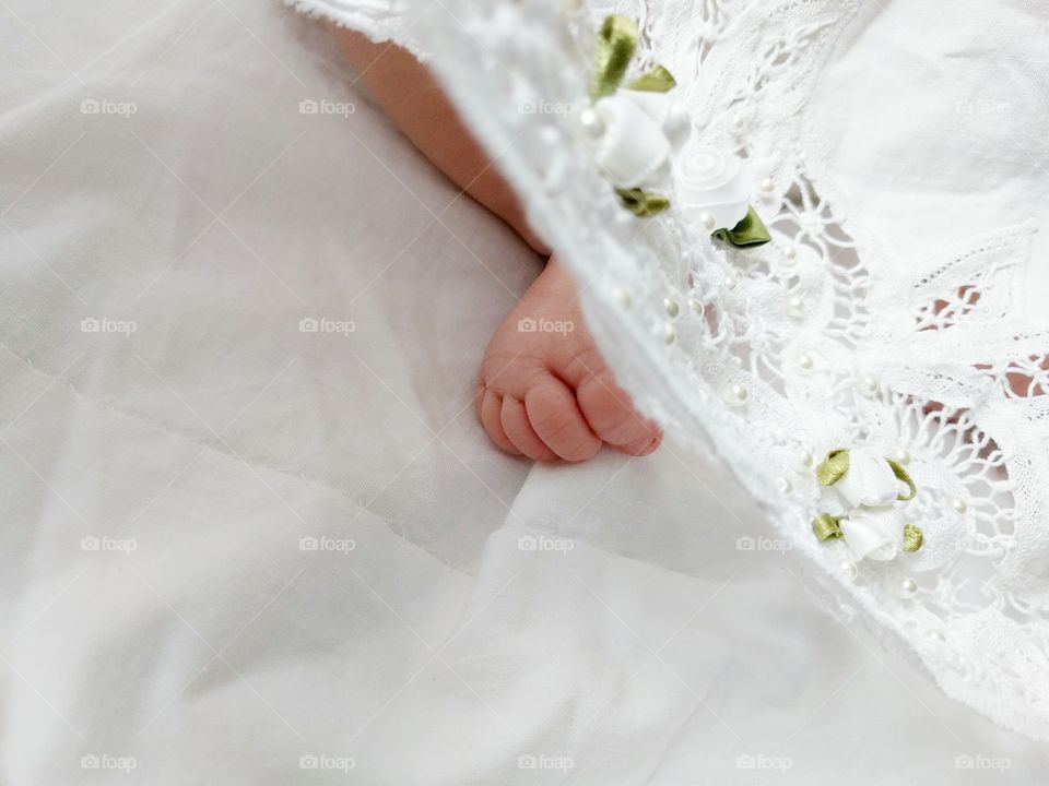 Baby's Foot with Lace on White