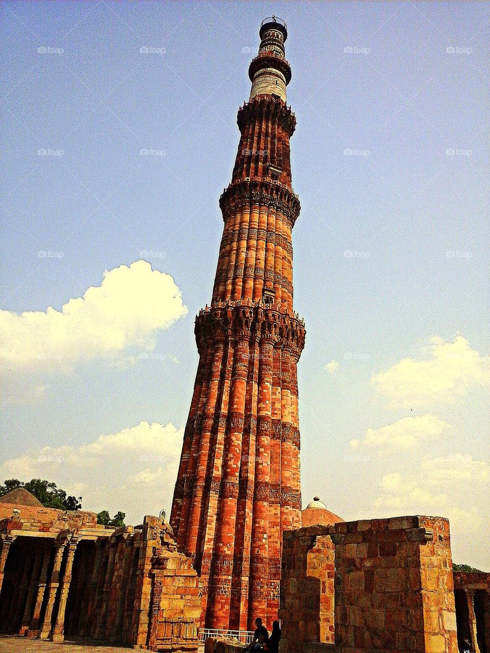 Qutb-Minar in red and buff standstone is the highest tower in India. It has a diameter of 14.32 m at the base and about 2.75 m on the top with a height of 72.5 m.
Qutbu'd-Din Aibak laid the foundation of Minar in AD 1199 for the use of the mu'azzin (crier) to give calls for prayer and raised the first storey, to which were added three more storeys by his successor and son-in-law, Shamsu'd-Din Iltutmish (AD 1211-36).