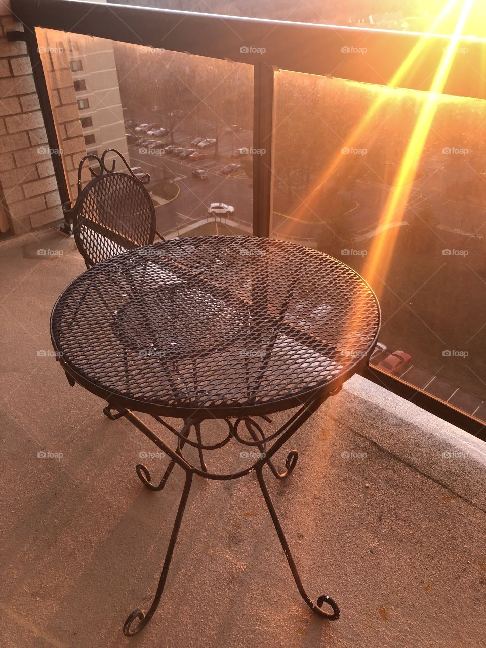 Table for one with a balcony view and a sunset