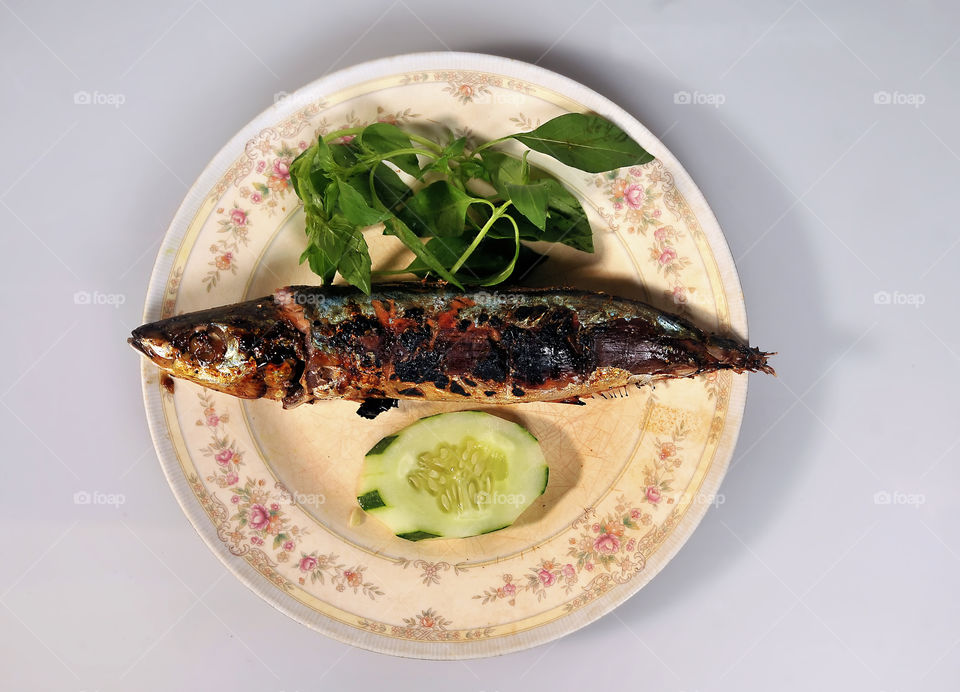 grilled fish and vegetables on a plate