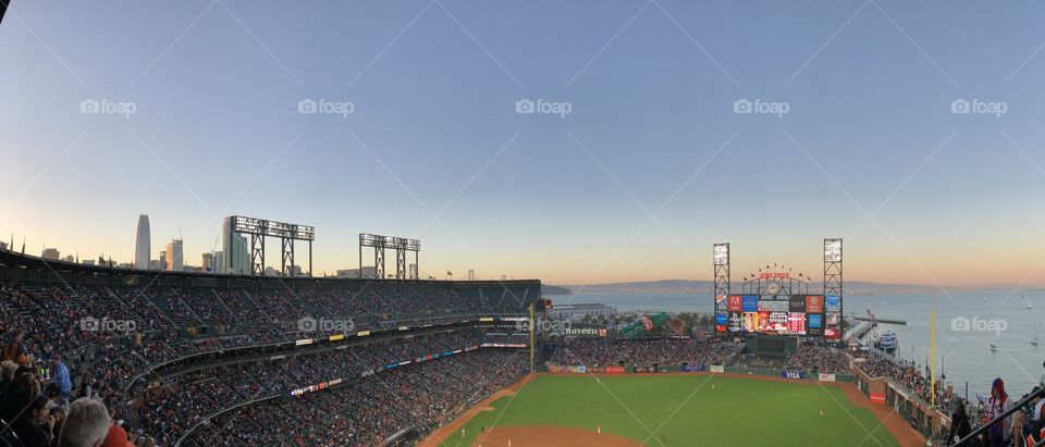 View of AT&T park in San Francisco, California during sunset at a Giants game from the top row