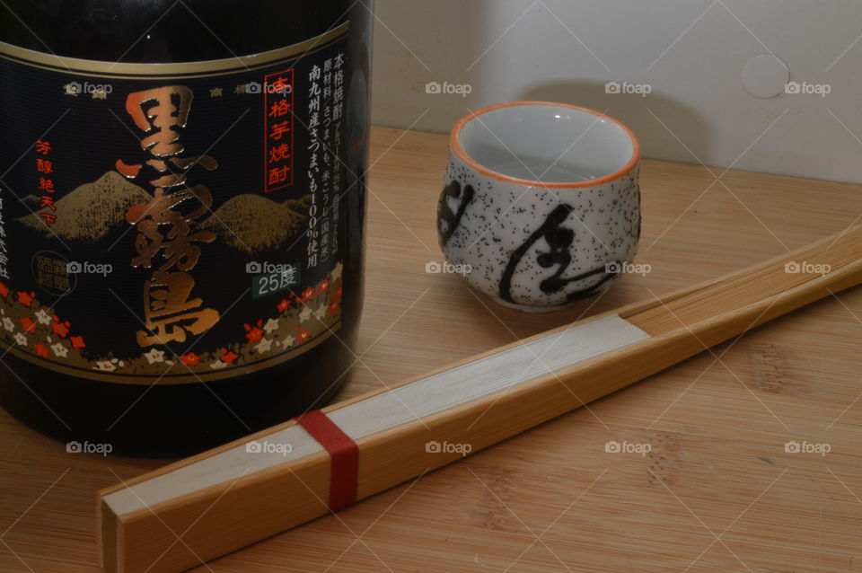 sake bottle cup and a hand fan