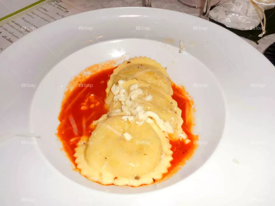 Italian ravioli with aurora tomato sauce in a restaurant of the Italian island of Ischia