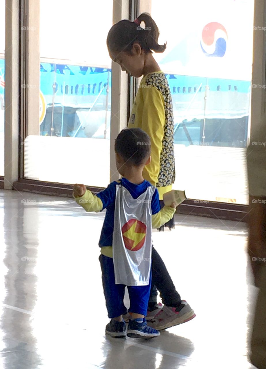 Super hero running through airport 