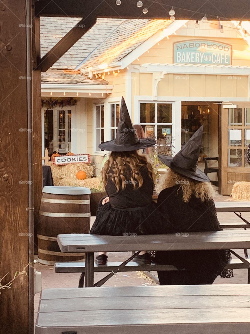 Just a couple of witches hanging out on their weekend off in their black hats and dresses. 
