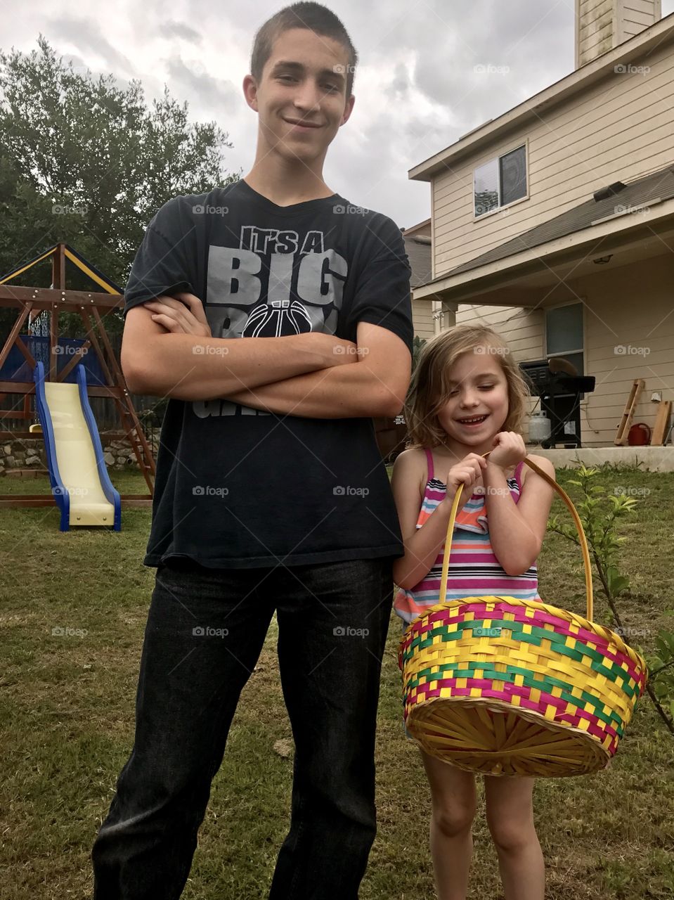 Teenage big brother and little sister on Easter 