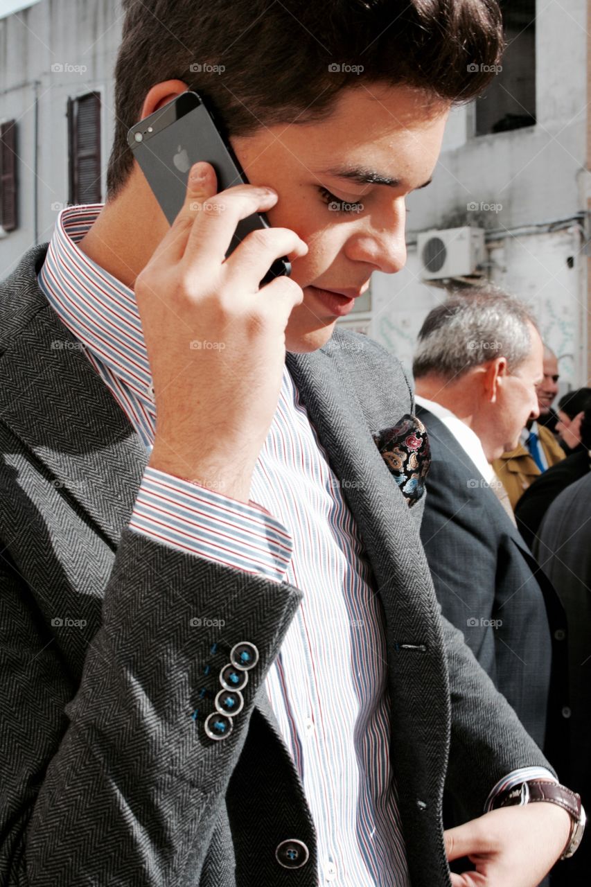 Young man holding mobile phone in hand
