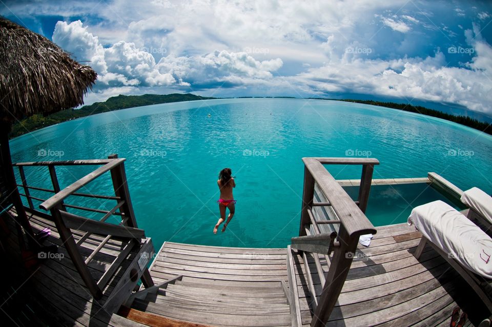 Jumping of the private dock in our villa at the Fourseasons, Bora Bora
