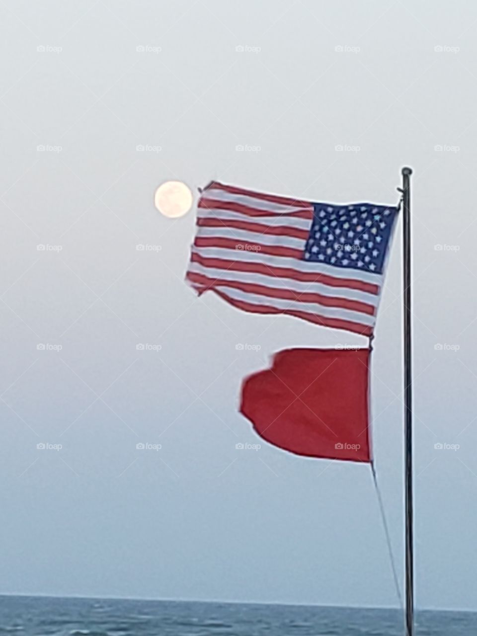 American flag, full moon causing riptides.