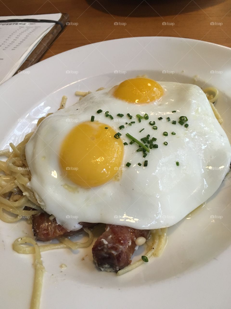 pasta with nuts, topped with egg
