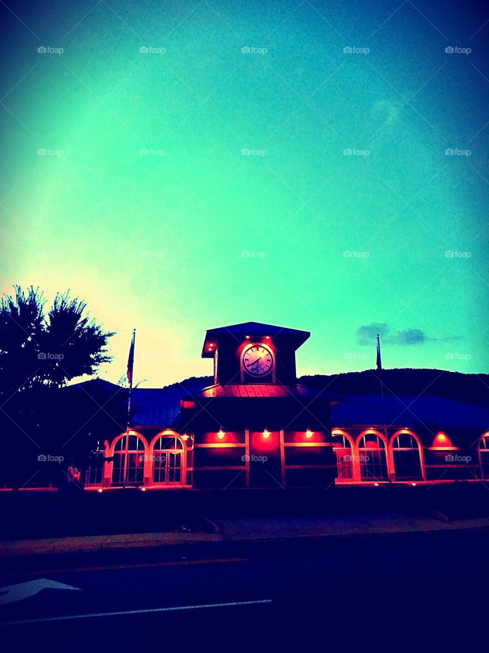 Beautiful City Hall with built-in clock illuminated by a gorgeous evening sky.