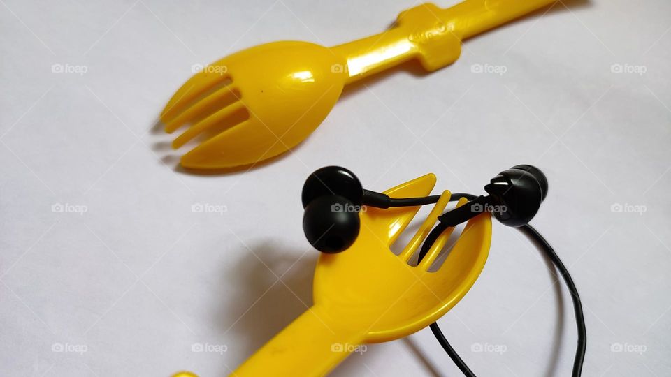 Yellow forks Trying to grab some music with earphones