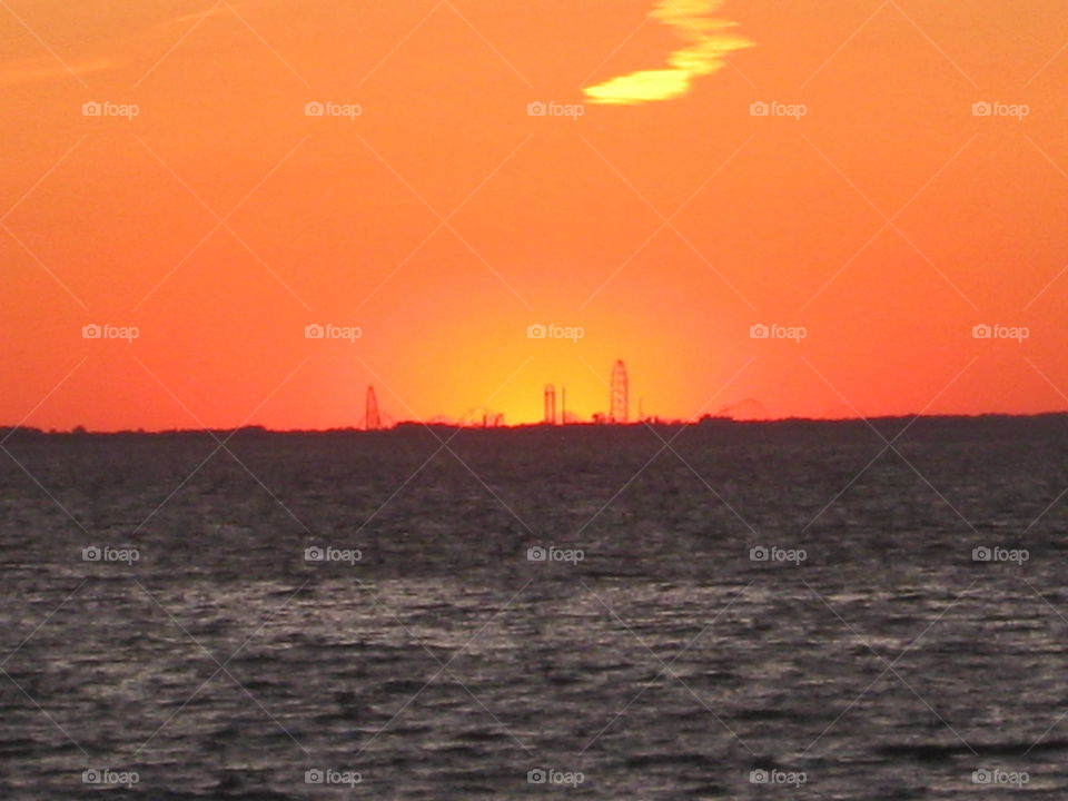 Cedar point from across Lake Erie backlit by sunset