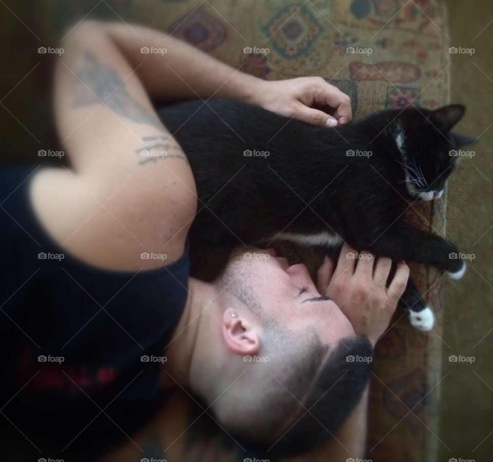 High angle view of a man sleeping with his cat
