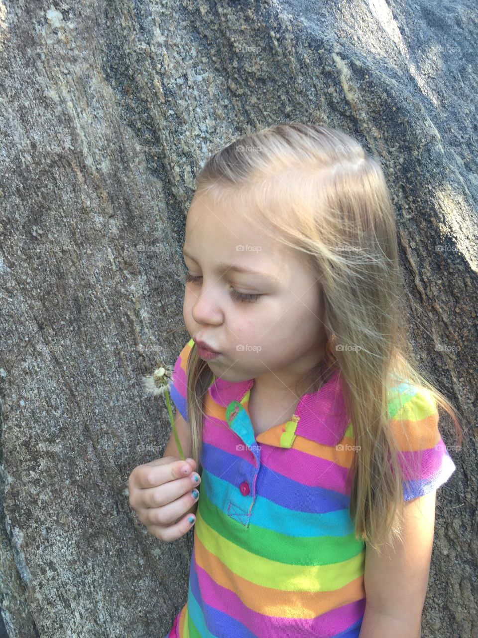 Little Girl Blowing Dandelion