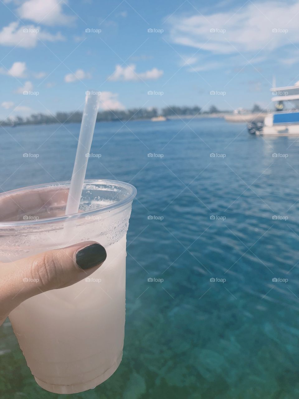 A warm summer day at the Bahamas complete with a refreshing coconut drink. 