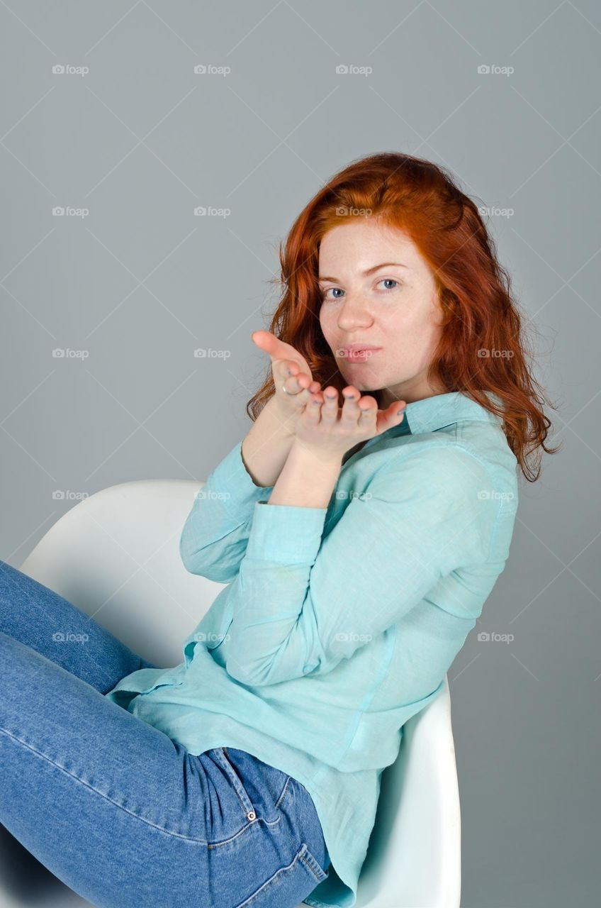 Close up portrait of beautiful young redhead woman,  girl in studio. Curly red hair. Lifestyle people