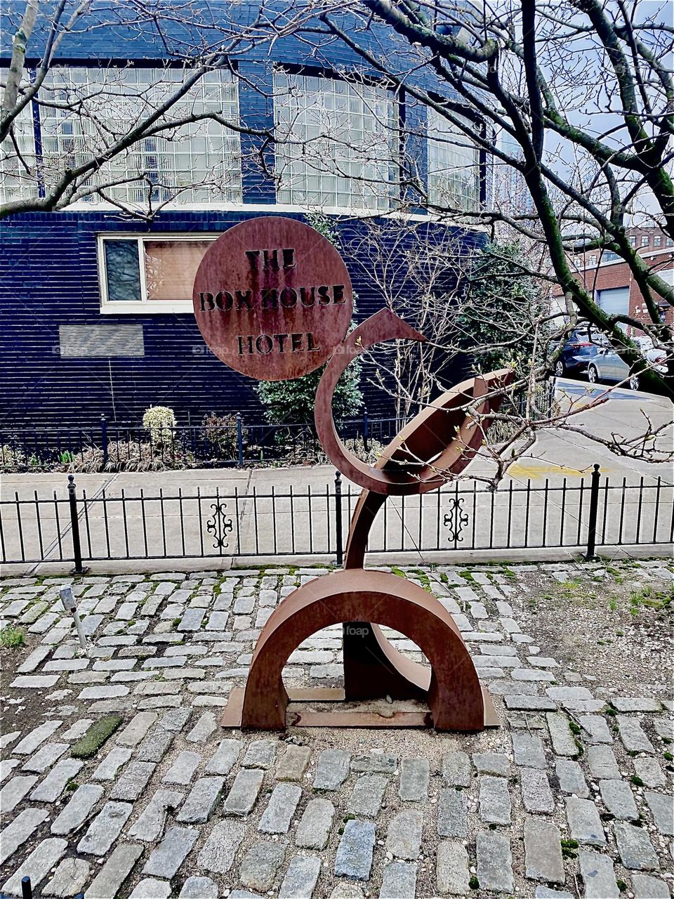The  “BOXHOUSE Hotel”  in “Greenpoint”, Bklyn at “Newtown Creek” by the “Pulaski Bridge” added a stylish modern art inspired abstract wooden sculpture sign in front of the building. 2023. Hypnotic Productions