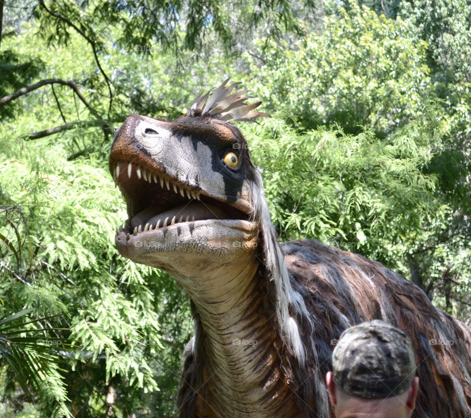 Close-up of scary Dinosaur in leafy surrounding. 